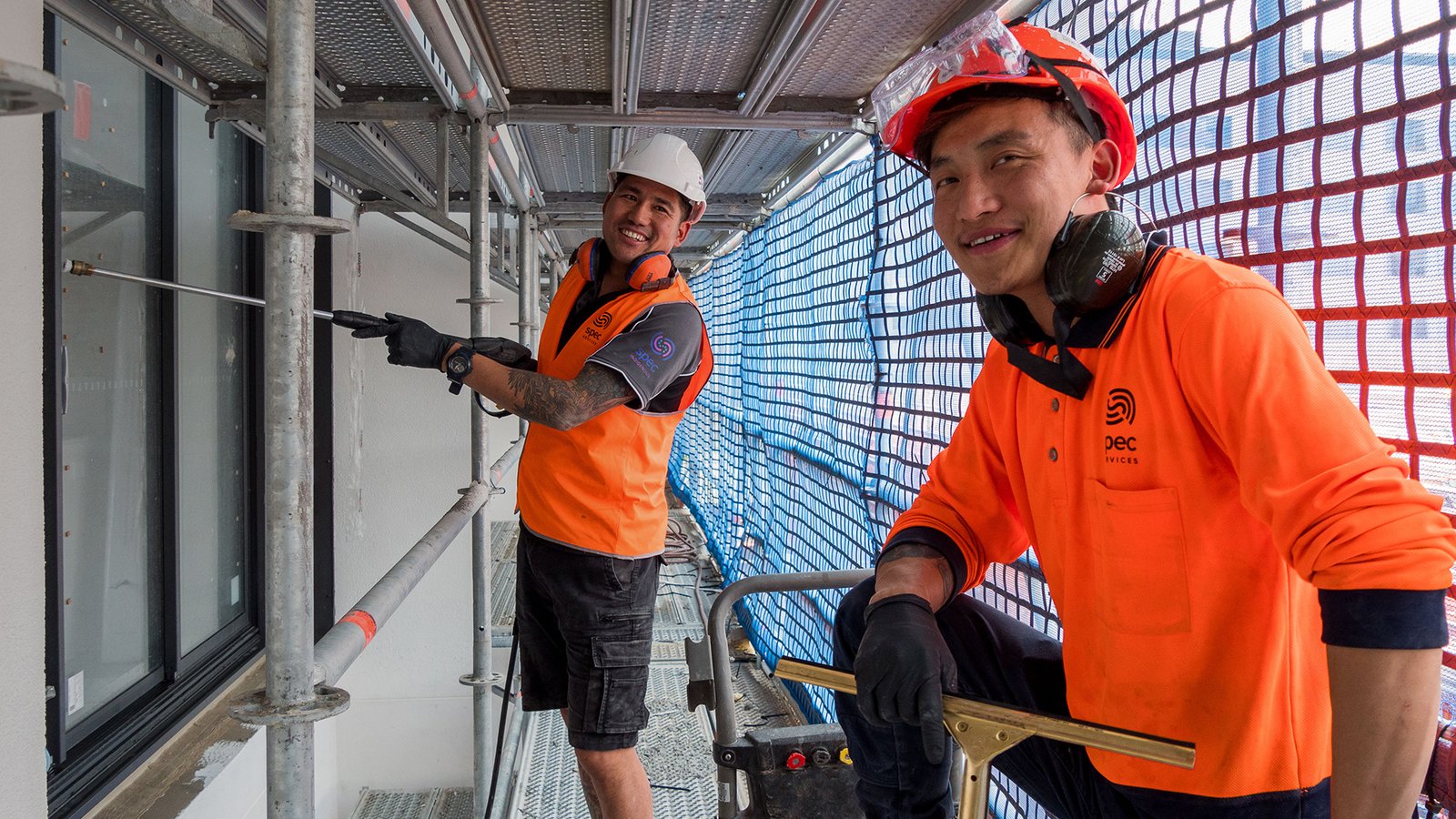 Window cleaning on scaffolding at a construction site