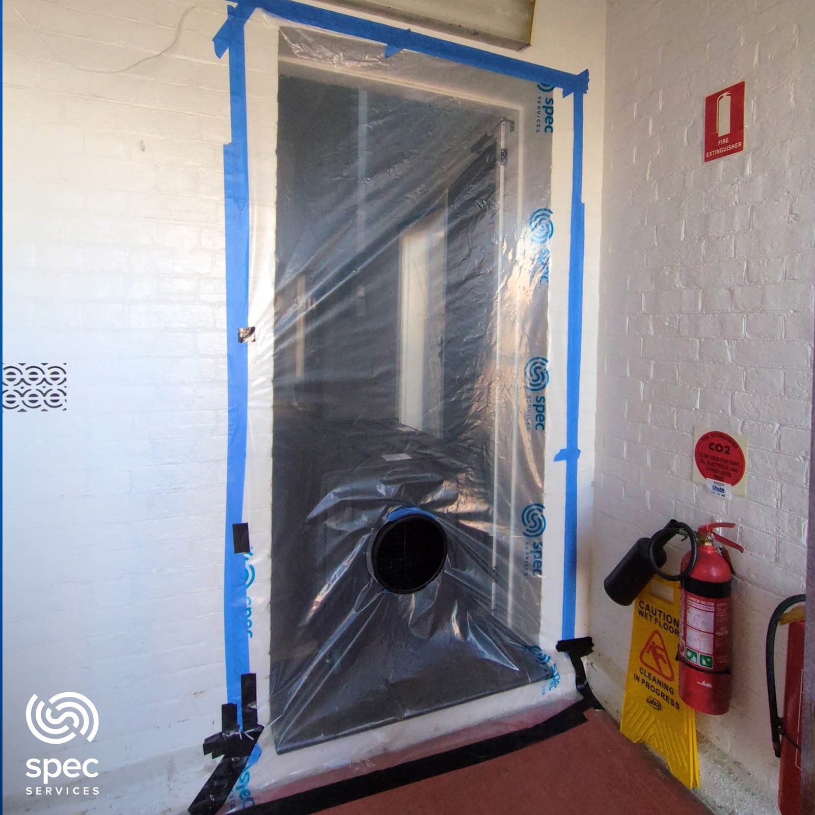 Contained doorway showing controlled remediation setup in a property